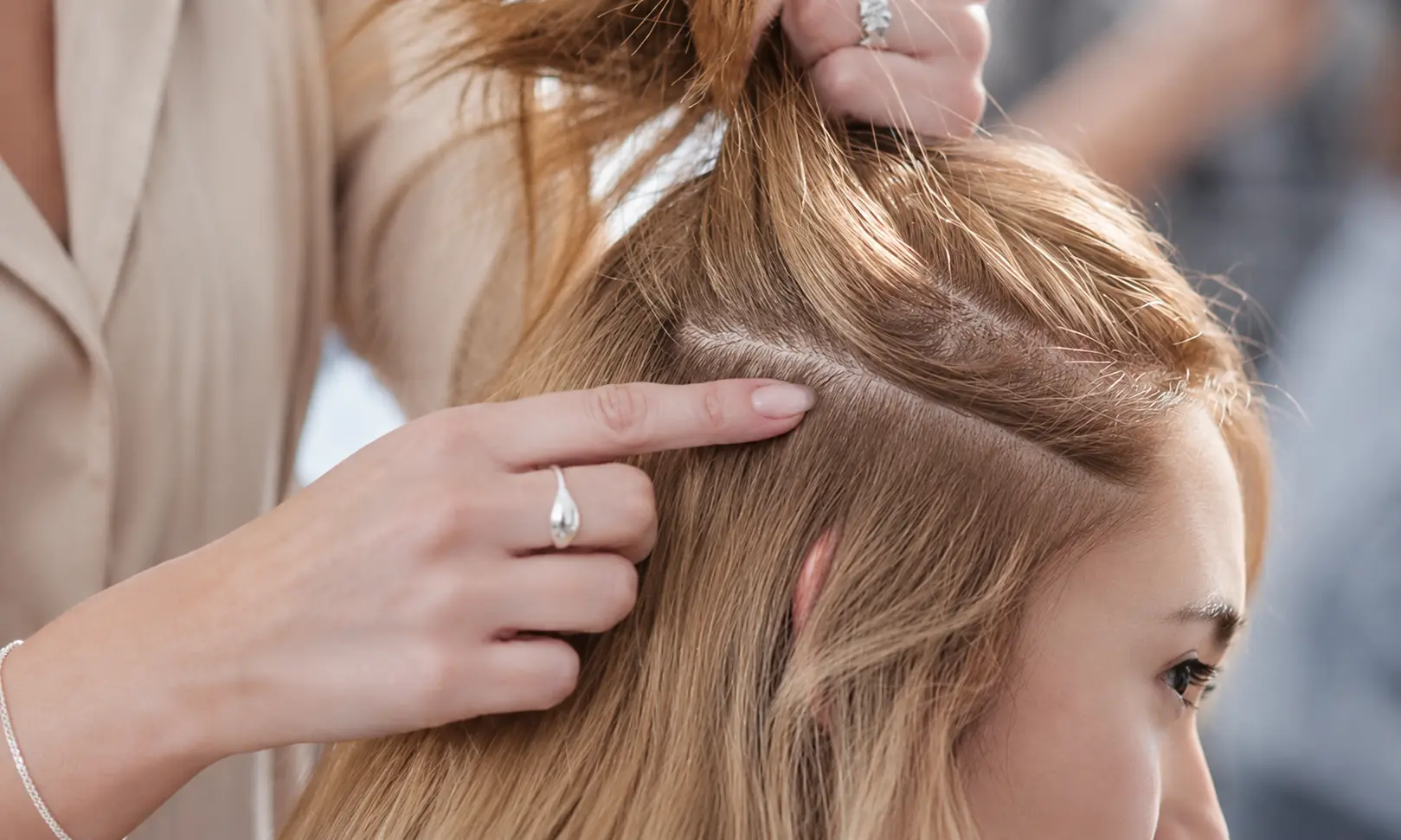 Woman gently lifting hair at the roots before styling
